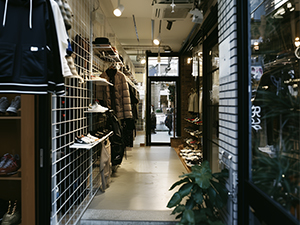 An image of an athletic store with tennis shoes sitting on a white wire grid display